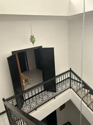 a staircase in a building with a hanging chain at Riad NYAH in Marrakech