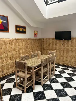 a dining room with a table and chairs at Riad NYAH in Marrakech