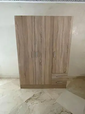 a wooden cabinet in the corner of a room at Confort et Style Studio Chic avec Piscine in Marrakech