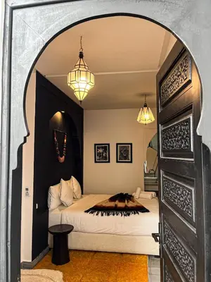 a bedroom with a bed and two chandeliers at Riad SASHA Exclusive&New Pool 6 pax Free Breakfast in Marrakech