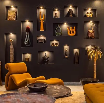 a living room with a black wall with a display of objects at Riad SASHA Exclusive&New Pool 6 pax Free Breakfast in Marrakech