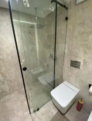 a bathroom with a toilet and a glass shower at Luxueux Duplex 3 chambres à Victor Hugo in Marrakech