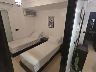 a room with two beds in a room with at Rita 83 in Marrakech