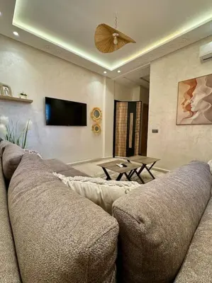 a living room with a couch and a ceiling fan at Yumo - Cozy 2 in Marrakech