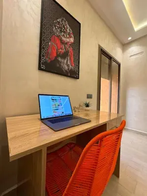 a laptop computer sitting on top of a wooden desk at Yumo - Cozy 2 in Marrakech