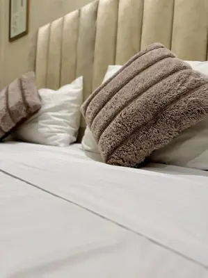 a white bed with two pillows on top of it at Yumo - La Vida in Marrakech