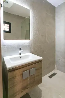 a bathroom with a sink and a mirror at L'Eden Suite - Marrakech Centre in Marrakech