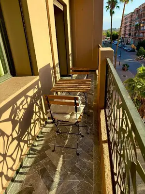 a balcony with two chairs and a railing on a building at Heart of Marrakech city center - Gueliz in Marrakech
