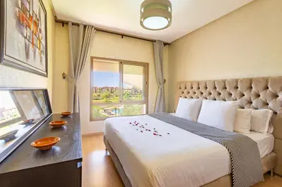 a hotel room with a bed and a window at Serene Oasis Pool & Garden View in Marrakech