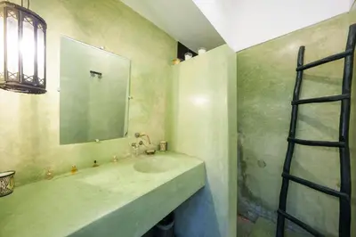 a bathroom with a sink and a mirror at Riad Ghita Exclusif 15 min de Jemaa El Fnaa in Marrakech