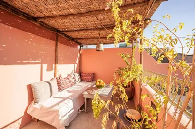 a porch with a couch and a table at Riad Ghita Exclusif 15 min de Jemaa El Fnaa in Marrakech