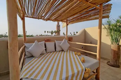 a bed on the balcony of a house at Riad Ouladi -Exclusif - 5mn Jemaa El Fnaa -Pool in Marrakech