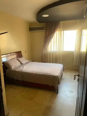 a bedroom with a large bed with a window at Appartement de Lux,Guèliz in Marrakech
