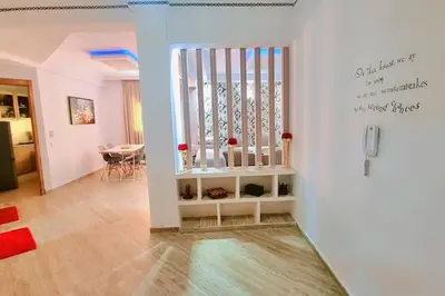 a living room with a staircase and a dining room at Spacieux Studio by Nina in Marrakech