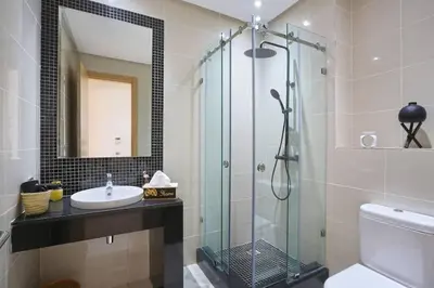 a bathroom with a sink and a glass shower at GOLF PRESTIGIA Résidence TOPAZE in Marrakech