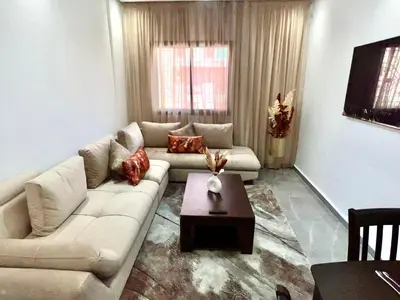 a living room with a couch and a coffee table at Appartement familiale top one saada in Marrakech