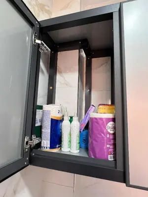 a shelf in a bathroom with toiletries at Appartement familiale top one saada in Marrakech