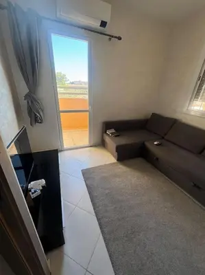 a living room with a couch and a large window at EuroOriental house in Marrakech