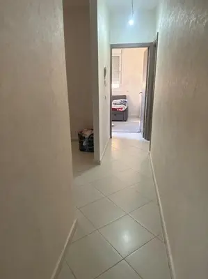 a hallway with a white tiled floor in a house at EuroOriental house in Marrakech
