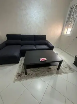 a living room with a blue couch and a coffee table at EuroOriental house in Marrakech