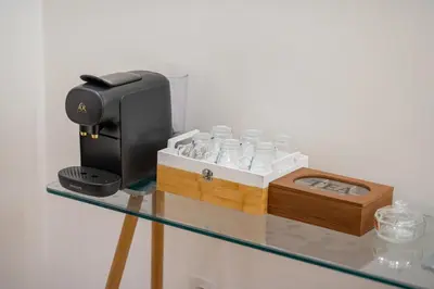 a glass table with a coffee maker and glasses on it at VISTA HOLIDAYS ctm in Marrakech