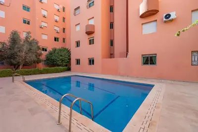 a swimming pool in front of a building at VISTA HOLIDAYS Warda A31 in Marrakech