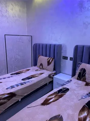 a room with two beds with feathers on them at Cosy et Agréable Appartement in Marrakech