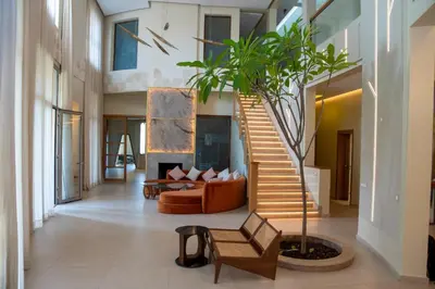a living room with a staircase and a couch at Villa 