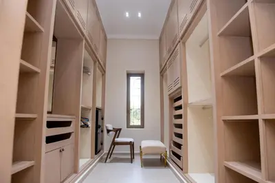 a walk in closet with a table and a chair at Villa 