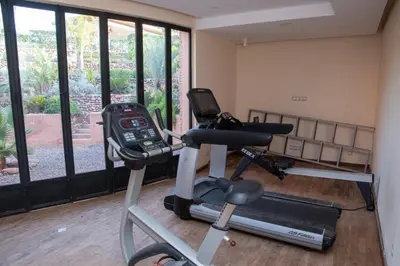 a gym with a exercise bike and a treadmill at Villa 