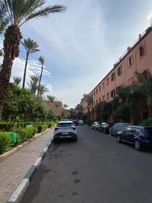 a street with cars parked on the side of the road at Riyad piscine intérieure privative in Marrakech