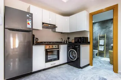 a kitchen with a refrigerator and a dishwasher at Bohemian Style in hyper-center - Wifi in Marrakech