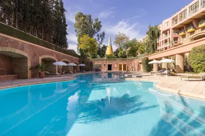 a large swimming pool next to a building at Romantic Retreat next to M avenue in Marrakech