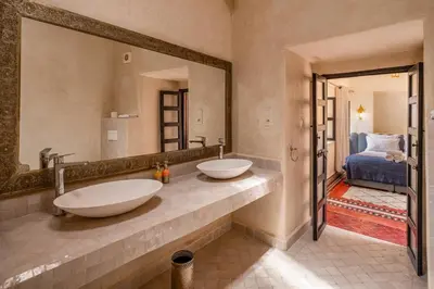 a bathroom with two sinks and a large mirror at Riad Akasia in Marrakech