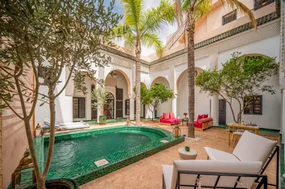 an indoor pool in a courtyard with palm trees at Riad Akasia in Marrakech