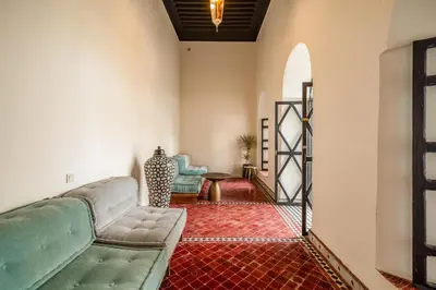 a living room with a couch and a table at Riad Akasia in Marrakech