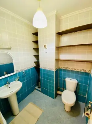 a blue and white bathroom with a toilet and a sink at Appart Moderne Calme & Climatisé in Marrakech