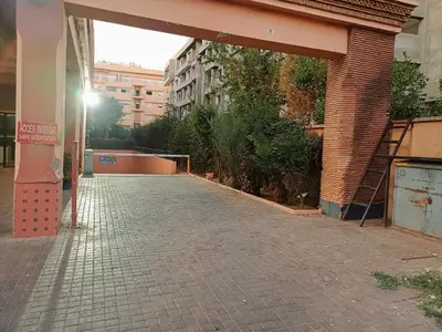 an empty street in a city with a building at Family Apartment with Pool in Marrakech