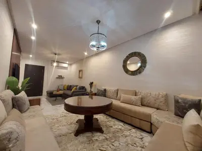 a living room with a couch and a table at Palm Appart in Marrakech