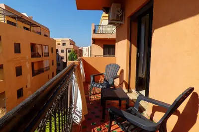 two chairs sitting on the balcony of a building at Cozy & Chic Appart Haut Standing Résidence Piscine in Marrakech