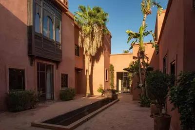an empty alley with palm trees and buildings at Exceptional villa on 10,000 meter square with heated pool in Marrakech