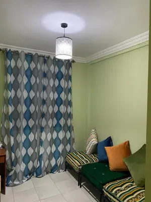 a living room with a couch and curtains at appartement in Marrakech