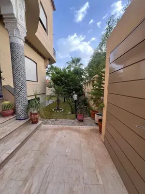 a driveway leading to a house with a garage at Villa La Baraka in Marrakech