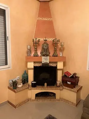 a living room with a fireplace in the corner at Villa La Baraka in Marrakech