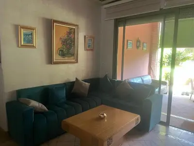 a living room with a blue couch and a coffee table at Marrakech 2 in Marrakech