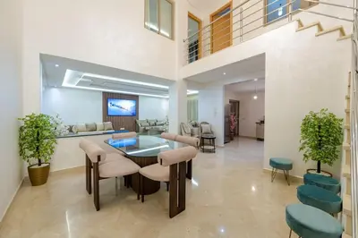 a living room with a table and chairs at Charming City Getaway in Marrakech