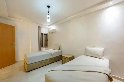 a hotel room with two beds and a window at Charming City Getaway in Marrakech