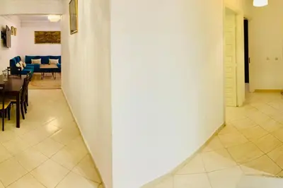 a hallway with a table and chairs in a room at Appart Moderne Calme & Climatisé in Marrakech