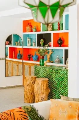 a living room with orange and blue shelves at Villa - Piscine chauffée sur demande et gouvernante in Marrakech