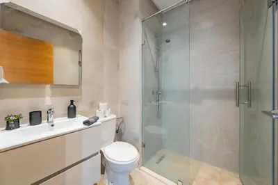 a bathroom with a shower and a toilet and a sink at Luxury and serenity in Prestigia Golf & Pool in Marrakech
